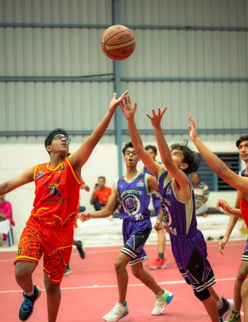 Royal Knights vs Hoopnotics — players reach for the rebound